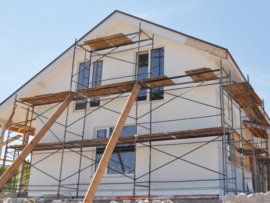 A house under construction with scaffolding around it