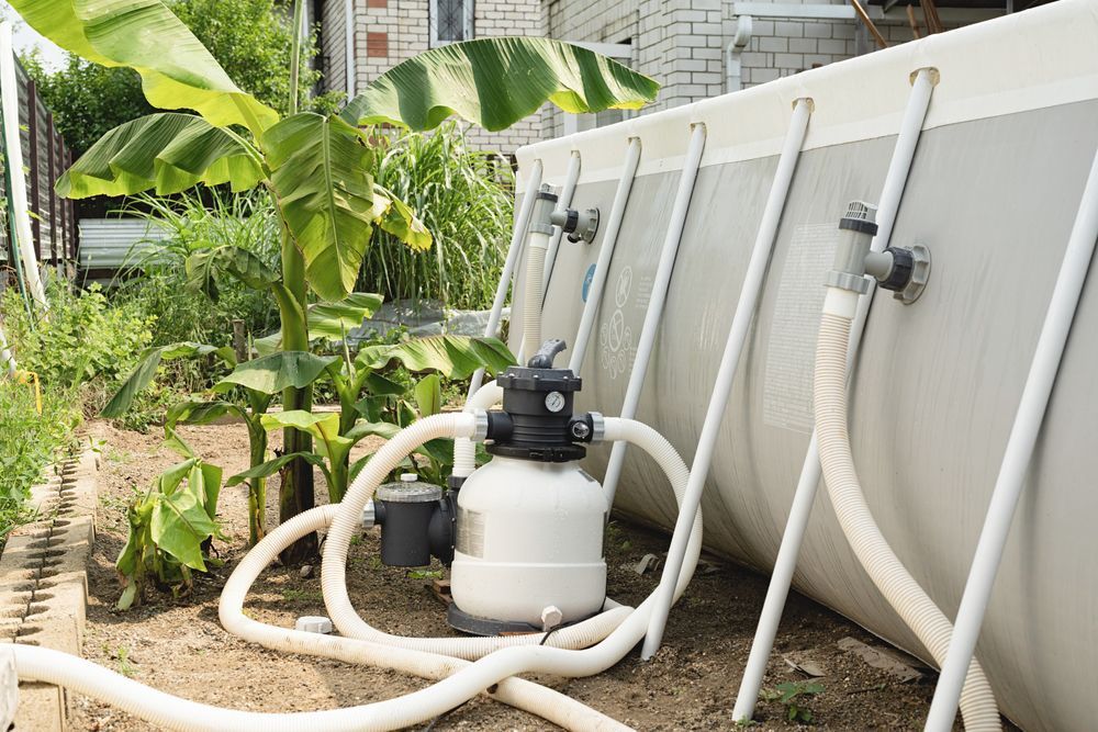 Garden Irrigation Setup With White Hoses, a Pump — Sun Cool Pools & Spas in Maryborough, QLD