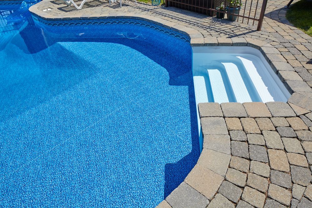 A Blue-tiled Swimming Pool Featuring White Molded Steps Leading — Sun Cool Pools & Spas in Maryborough, QLD