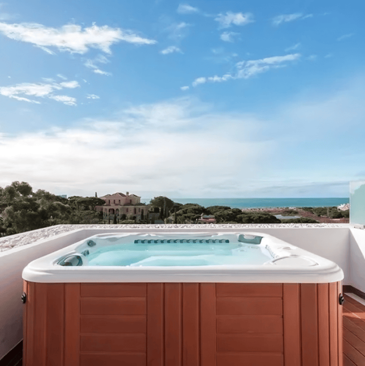 A Wood-paneled Hot Tub Sits on a Balcony Overlooking — Sun Cool Pools & Spas in Maryborough, QLD