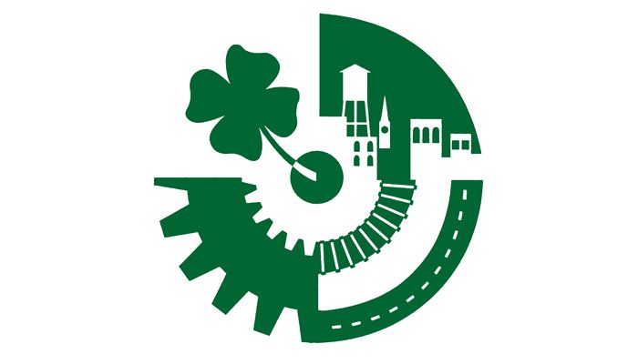 Green logo with shamrock, gear, and city buildings forming a circular industrial design