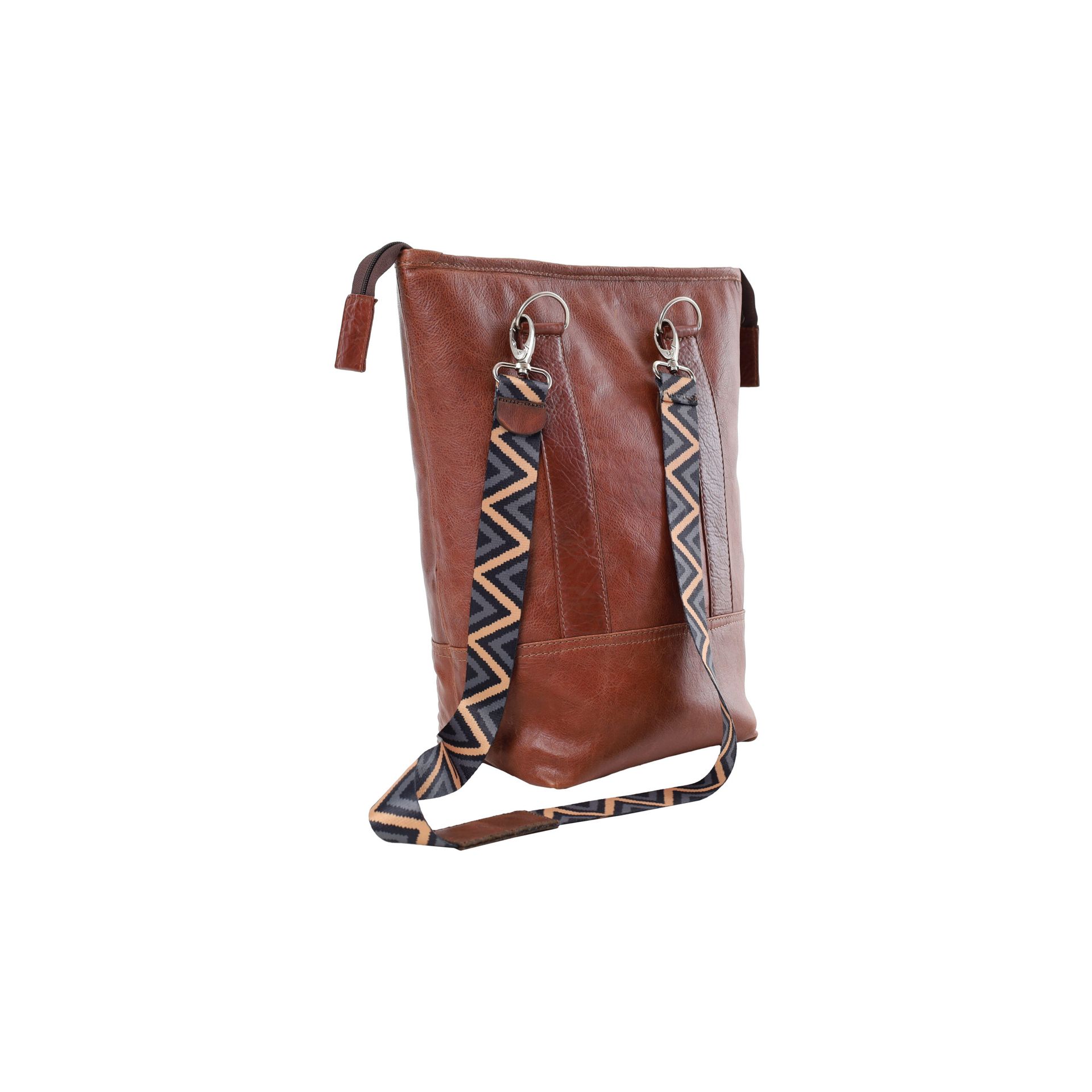 Brown leather crossbody bag with patterned strap and front pocket, isolated on white background