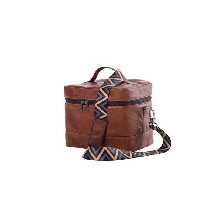 Brown leather round handbag with a zigzag patterned strap on a white background