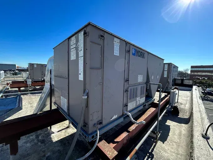 York HVAC units on a rooftop against a clear blue sky.