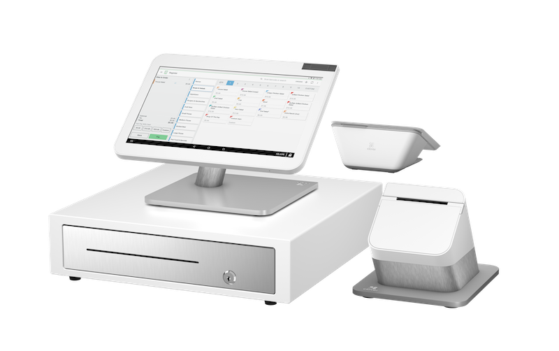 White point-of-sale touchscreen register with cash drawer and two receipt printers on a clean background