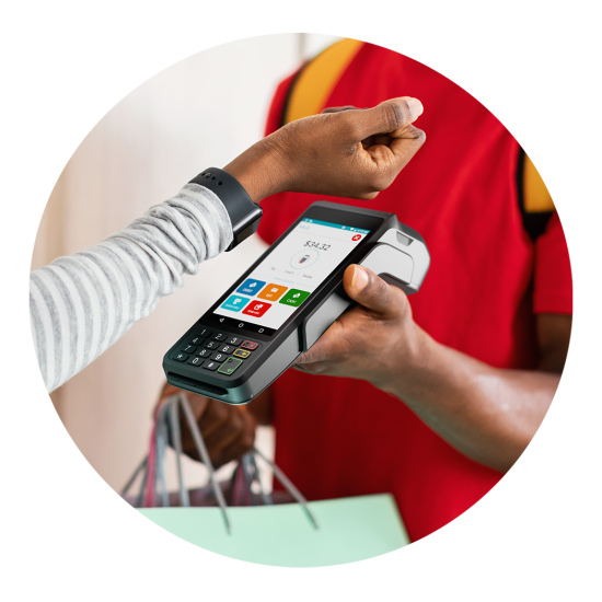 Person tapping card on a contactless payment terminal held by another person