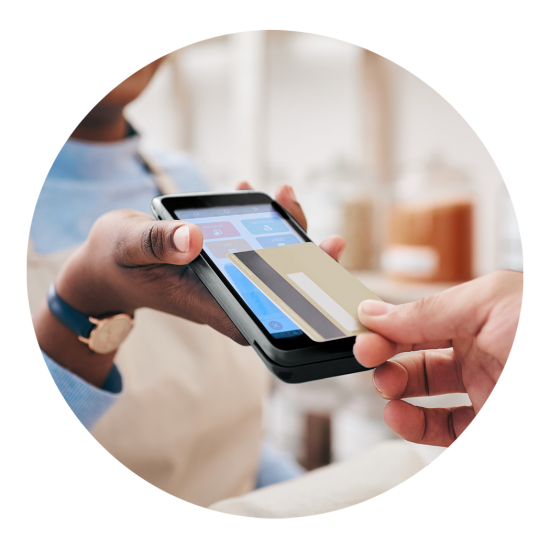 Person tapping a smartphone to make a contactless payment at a checkout counter