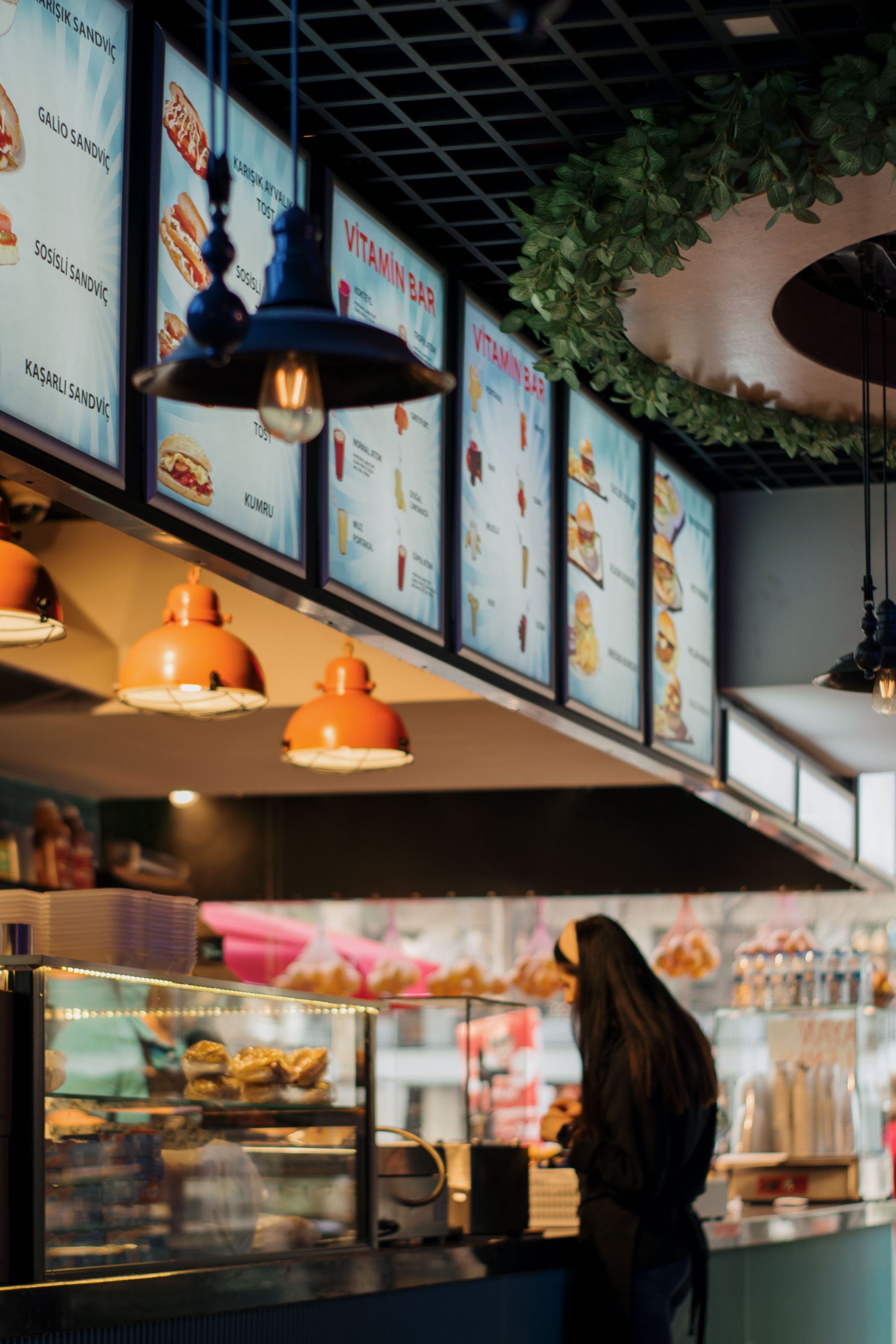 Purple restaurant touchscreen POS menu with food item tiles on a counter