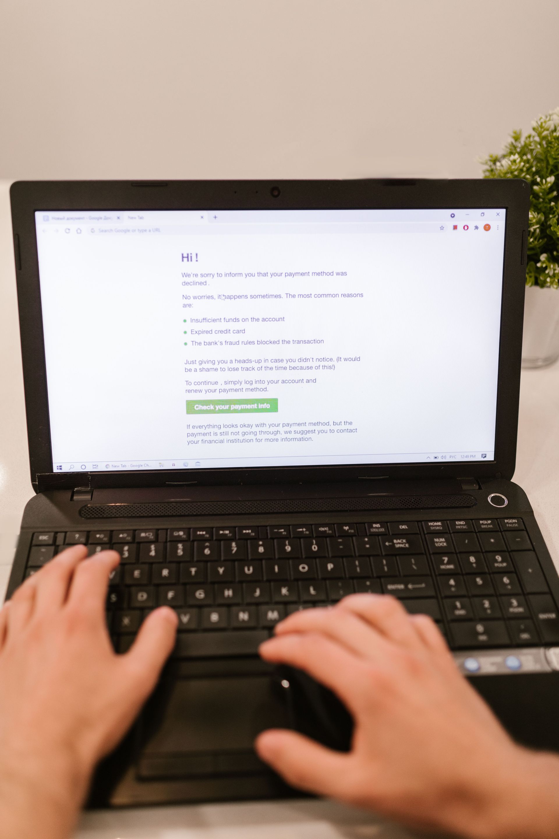 Business owner typing on a laptop to send a B2B invoice and online payment request