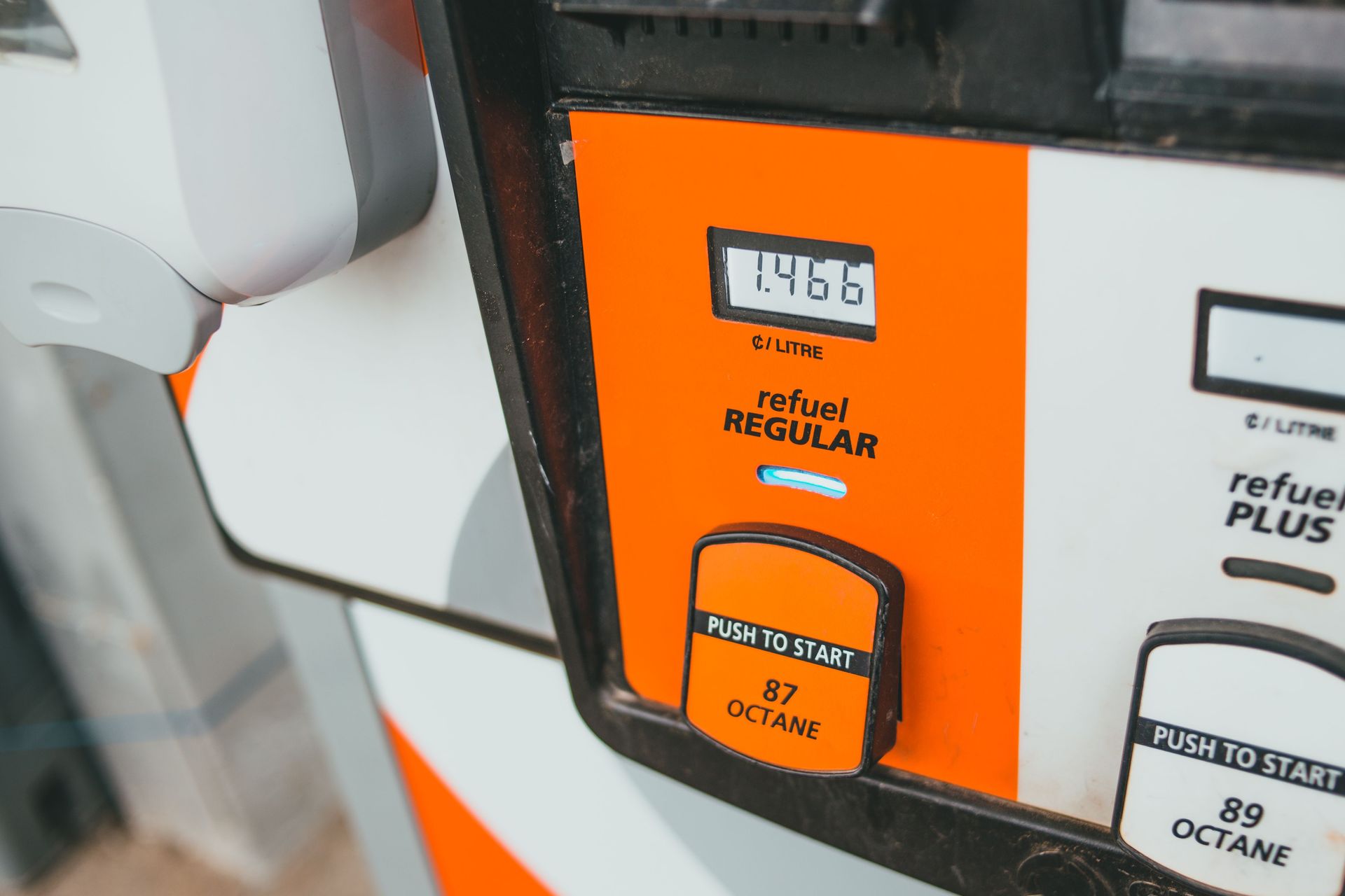 Gas pump display showing regular fuel selection and price, with orange and gray panel.