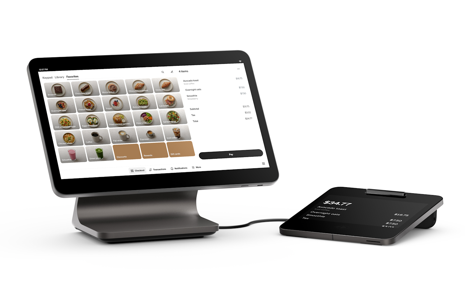 Touchscreen tablet showing a menu interface beside a small black payment terminal on a white background