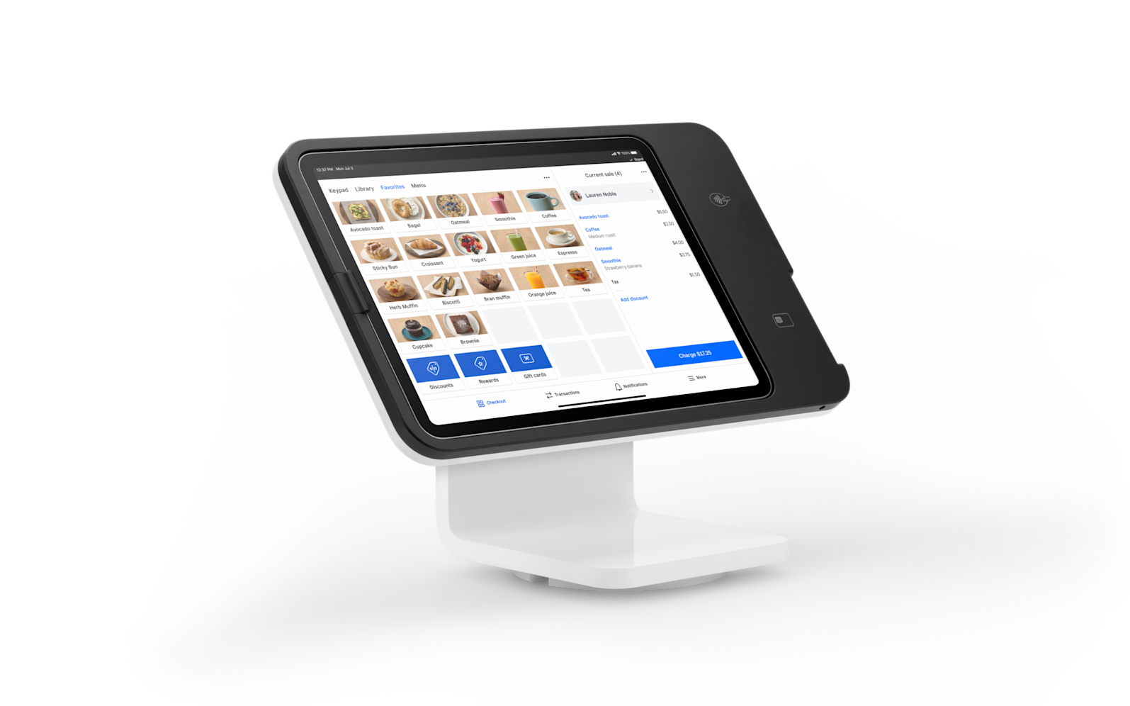 Tablet on a white stand displaying a retail app interface with product tiles and a blue button
