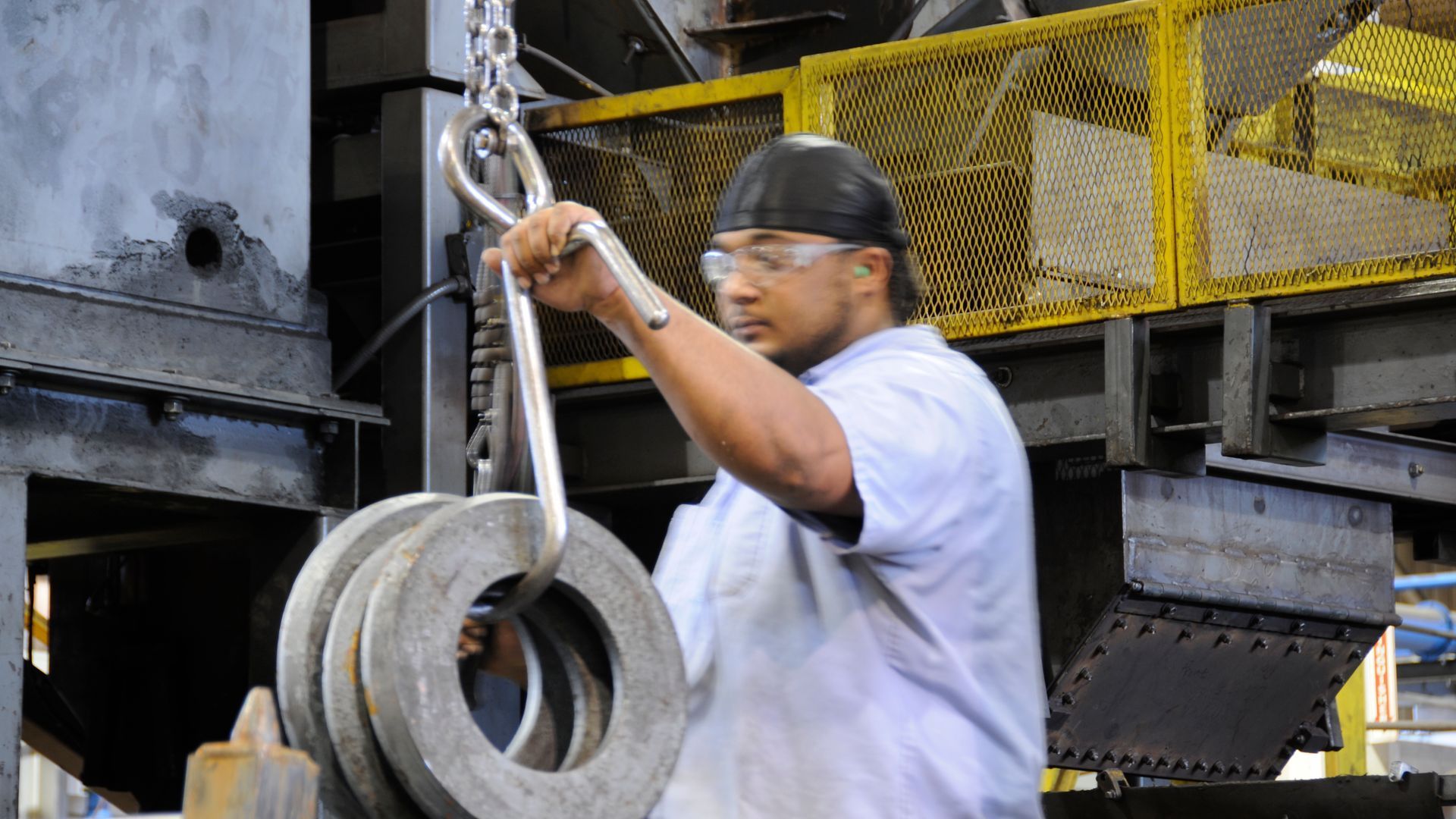 Man holding metal chain with large metal weights