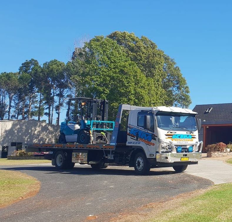 A Forklift Is On The Back Of A Tow Truck — KTM Towing In Kempsey, NSW