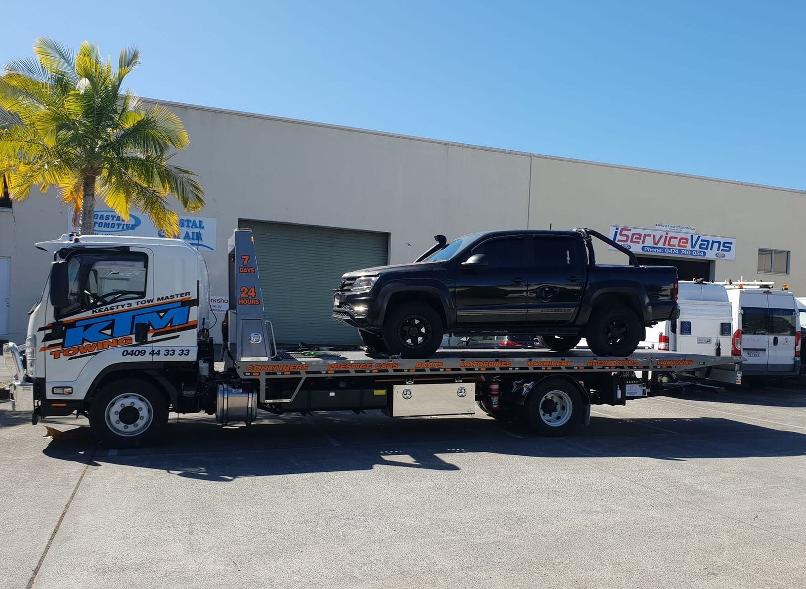 Broken Black Pickup Car Loaded Onto White Tow Truck — KTM Towing In Macksville, NSW