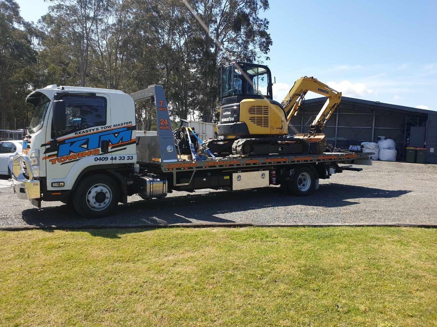 Heavy Yellow Excavator On A Transportation Truck — KTM Towing In Kempsey, NSW