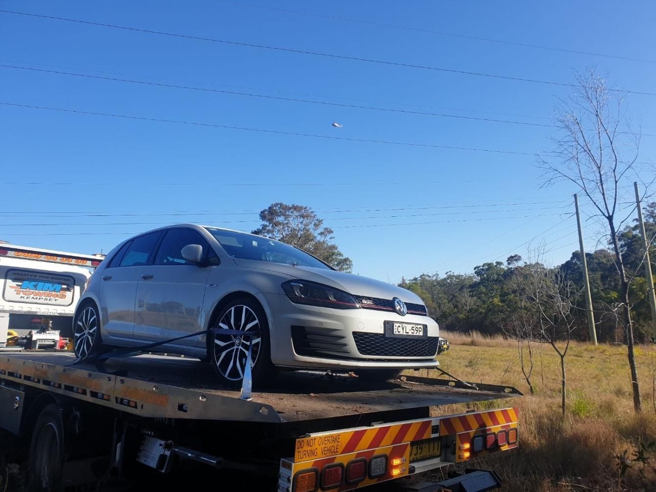 Big Tilt Tray Tow Truck Towing A Silver Volkswagen — KTM Towing In Kempsey, NSW