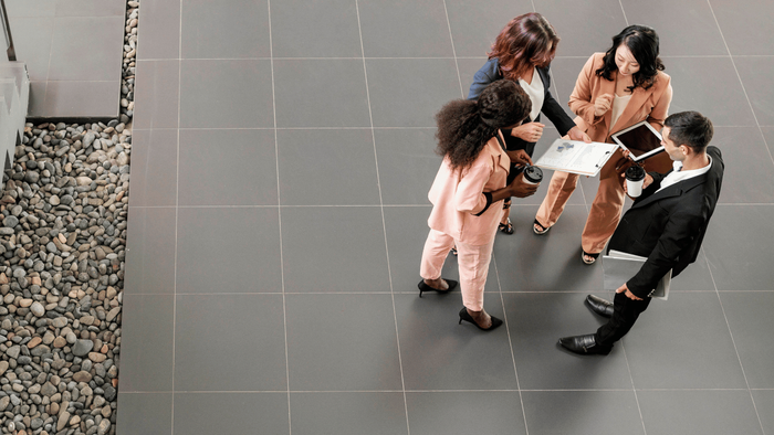 Foveo Consulting | Two women talking in an office setting