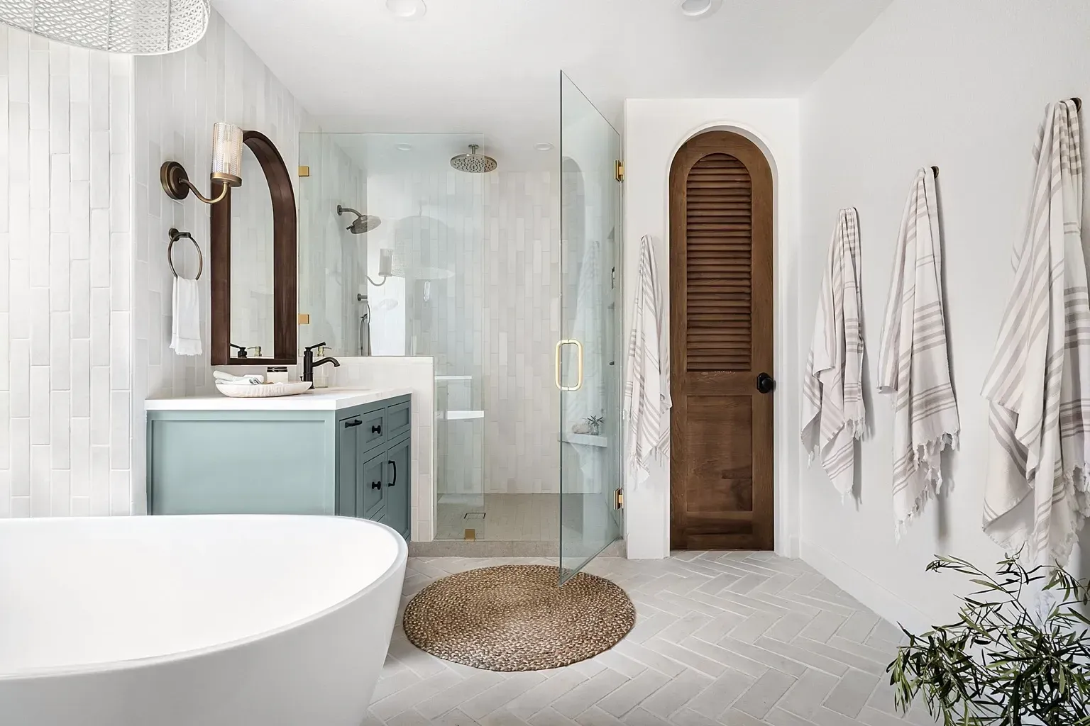 Elegant bathroom with glass shower, arched timber door, and freestanding tub in Lane Cove renovation”