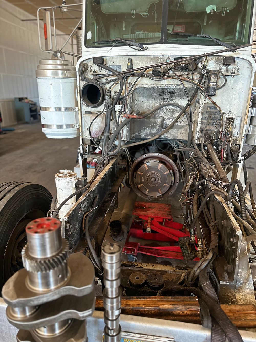 The engine of a semi truck is being removed.