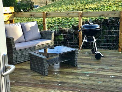 The Sun Rise Mega Pod decking area with barbecue at Queensland Holiday Park