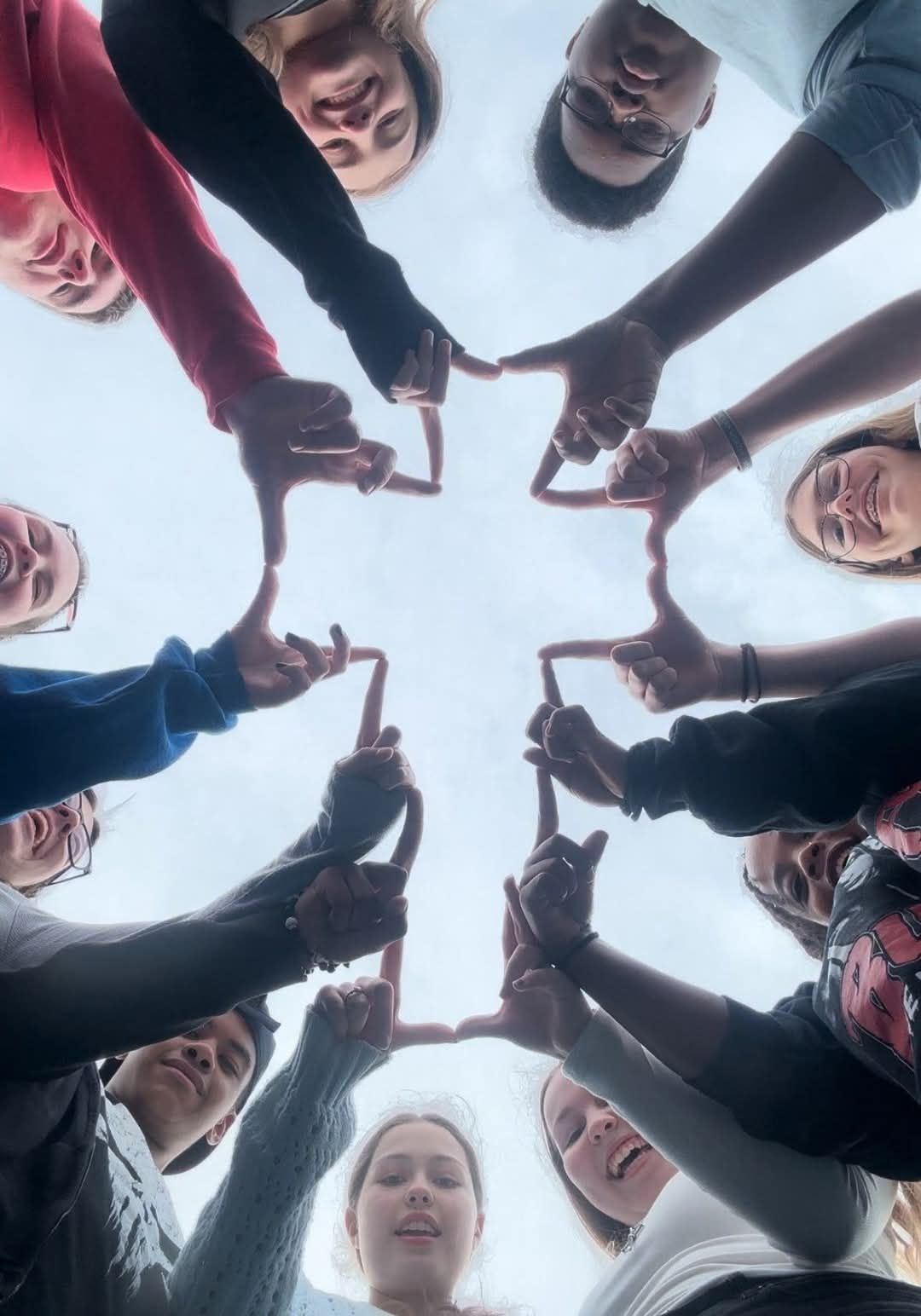 HUMC Youth on Retreat using their hands to make a cross