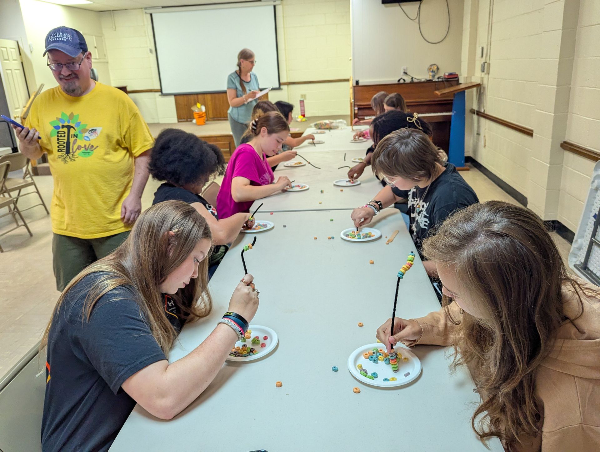 Youth using chopsticks and Fruit Loops to create master pieces.