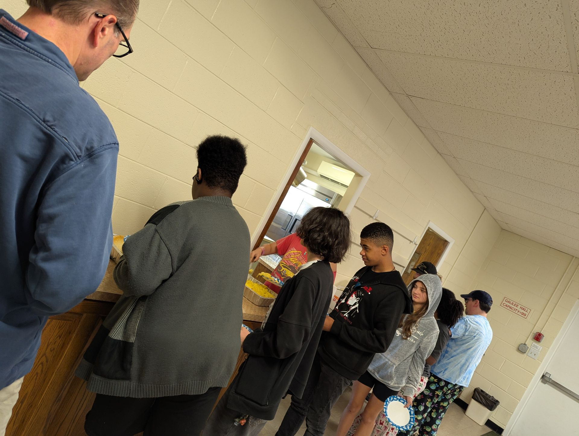 Youth waiting in line for breakfast after a lock-in.