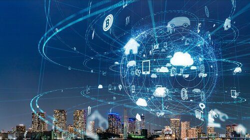 A city at night with a globe surrounded by icons of technology.