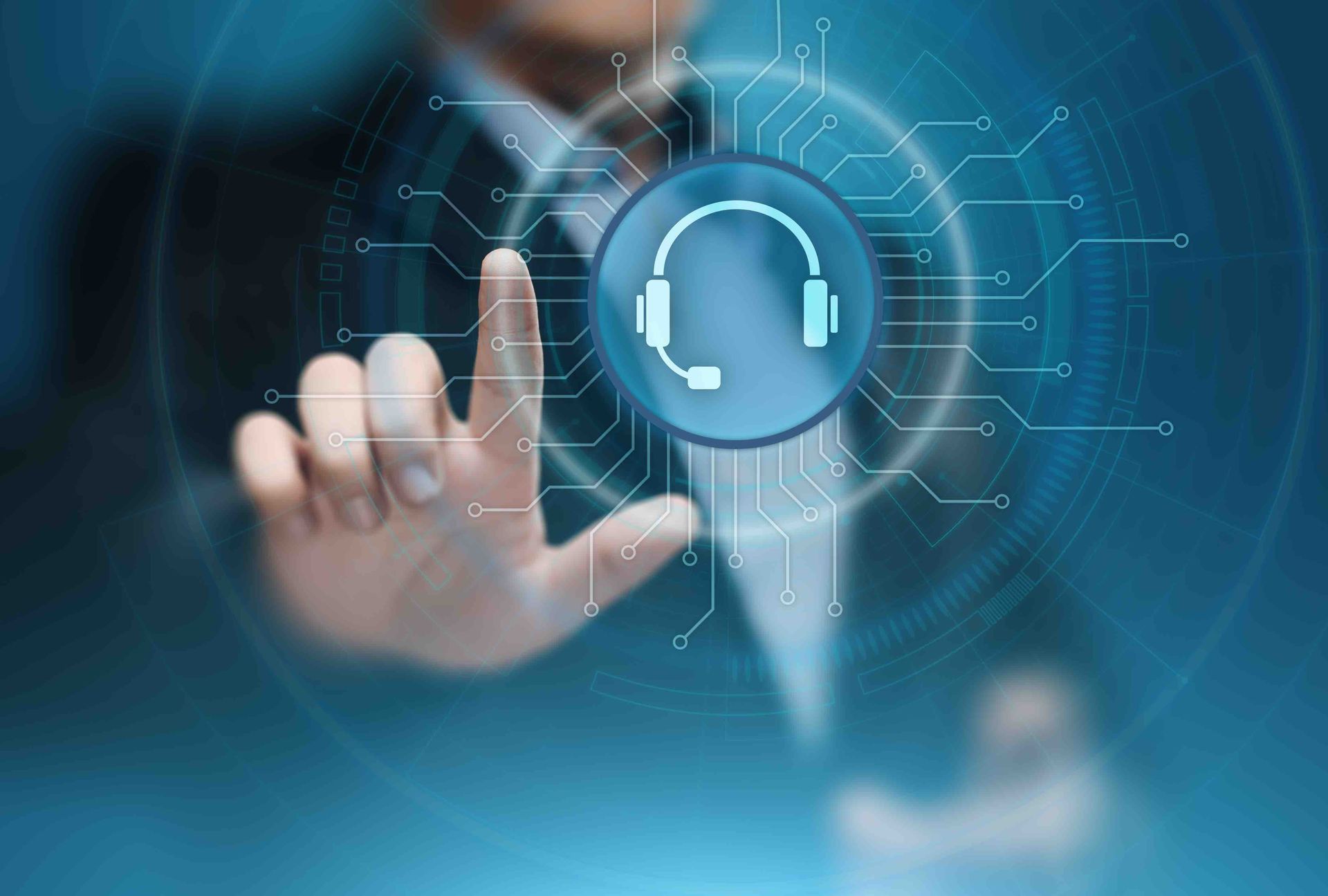 A man in a suit is pressing a button with a headset icon on it.