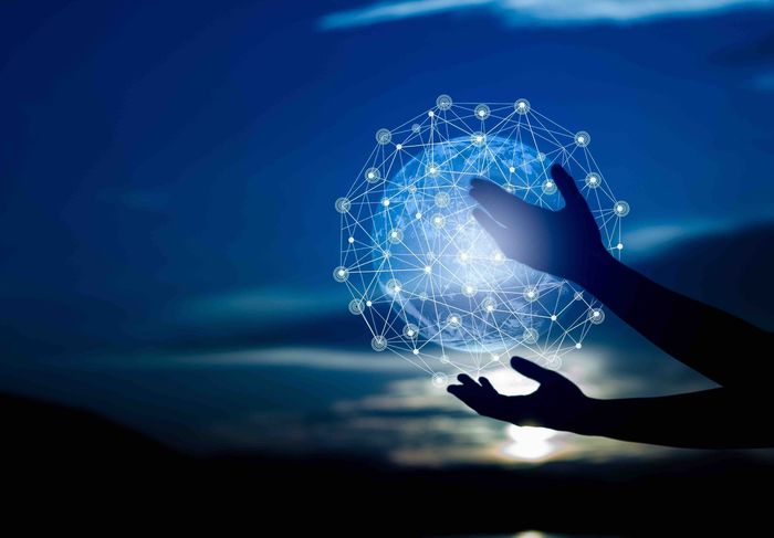 A person is holding a glowing sphere in their hands.