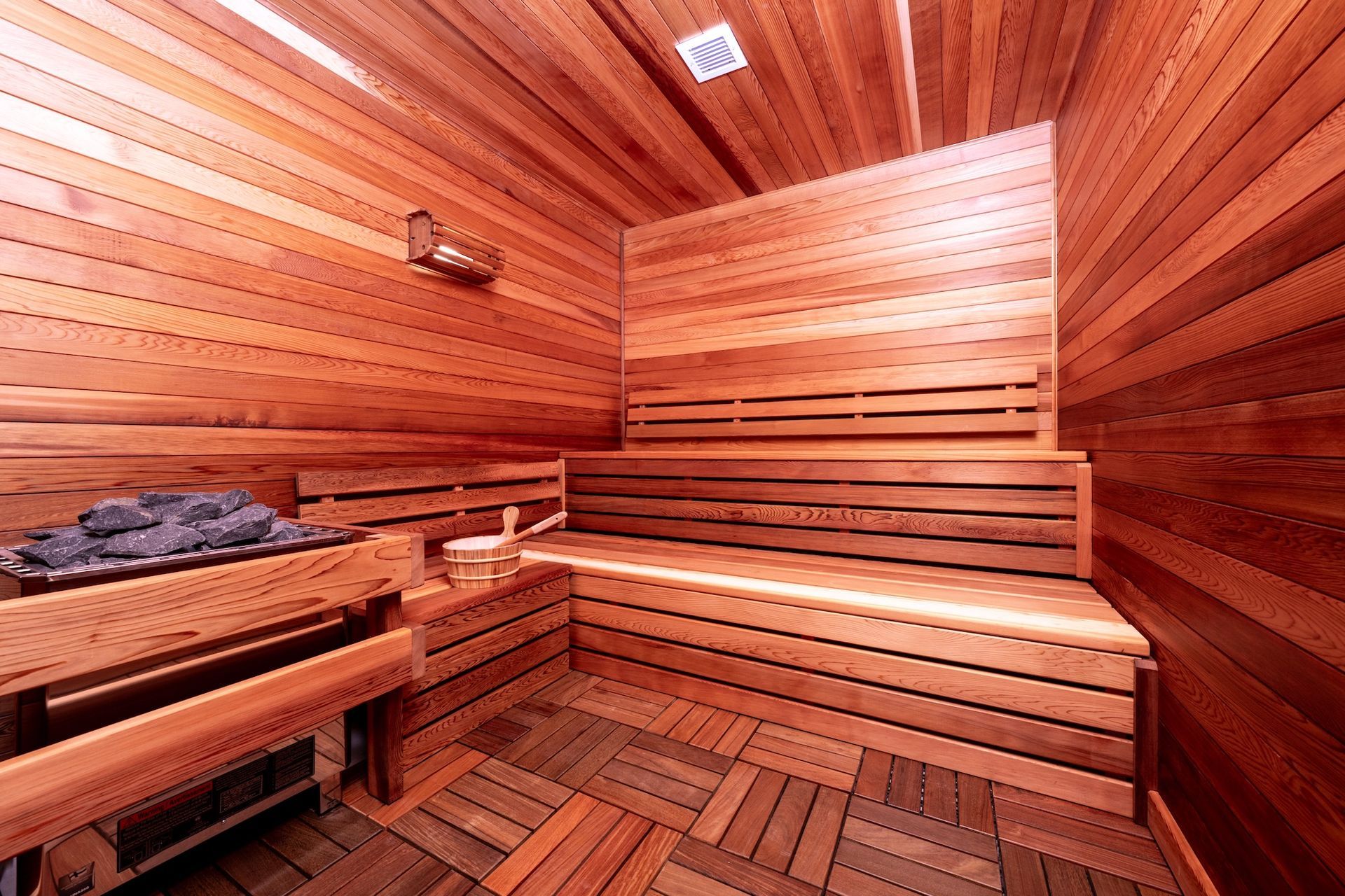 A wooden sauna with wooden benches and a wooden floor