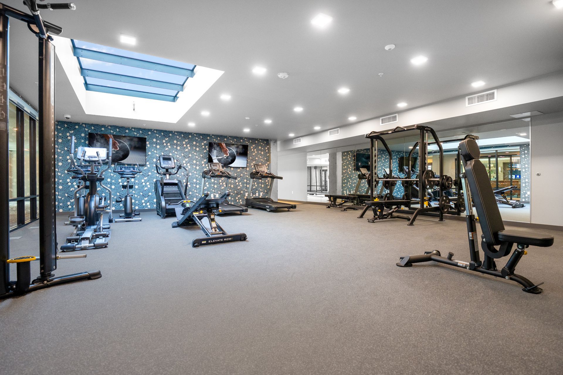 gym with equipment and skylights
