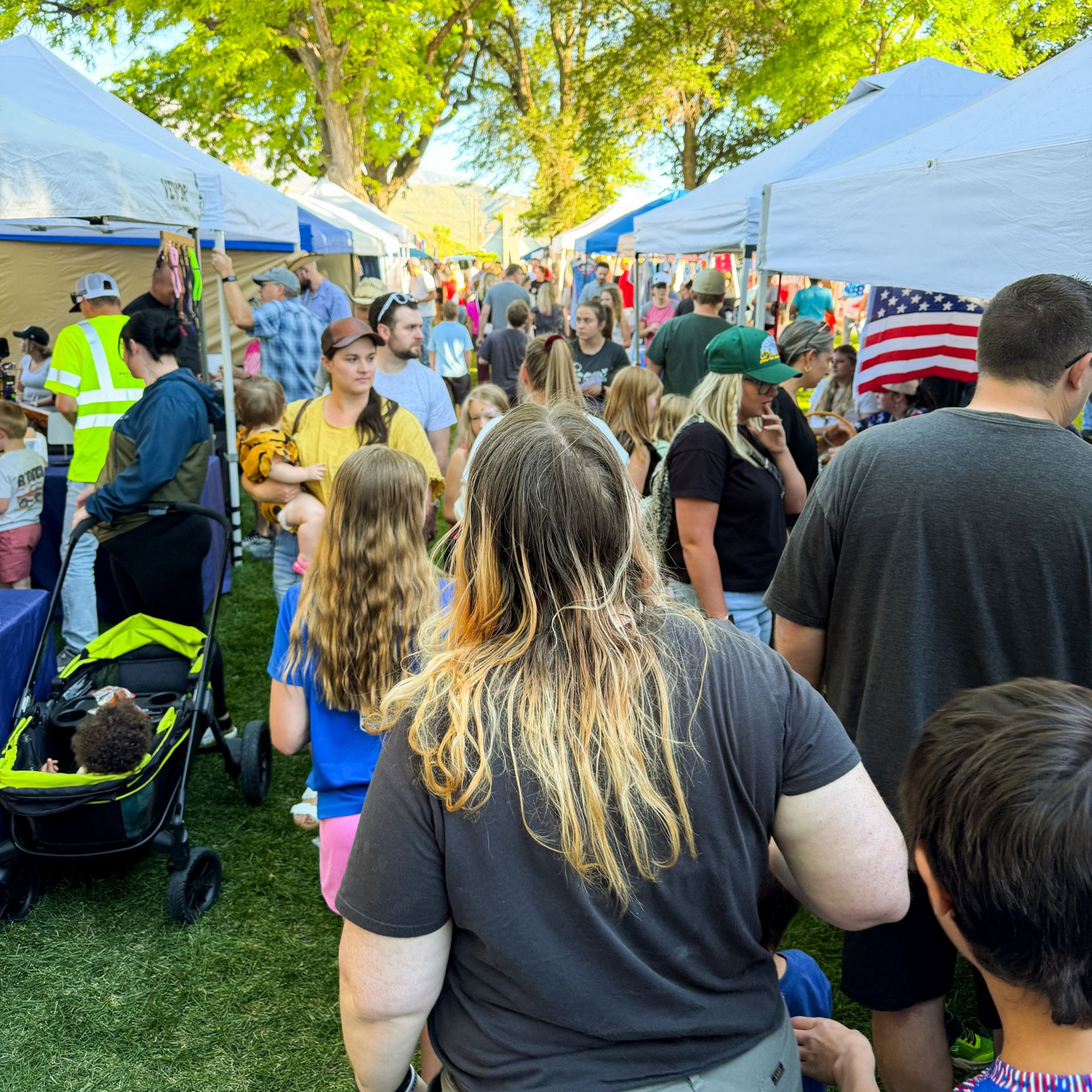 Photo of community members and local vendor booths at the Santaquin Hometown Market.