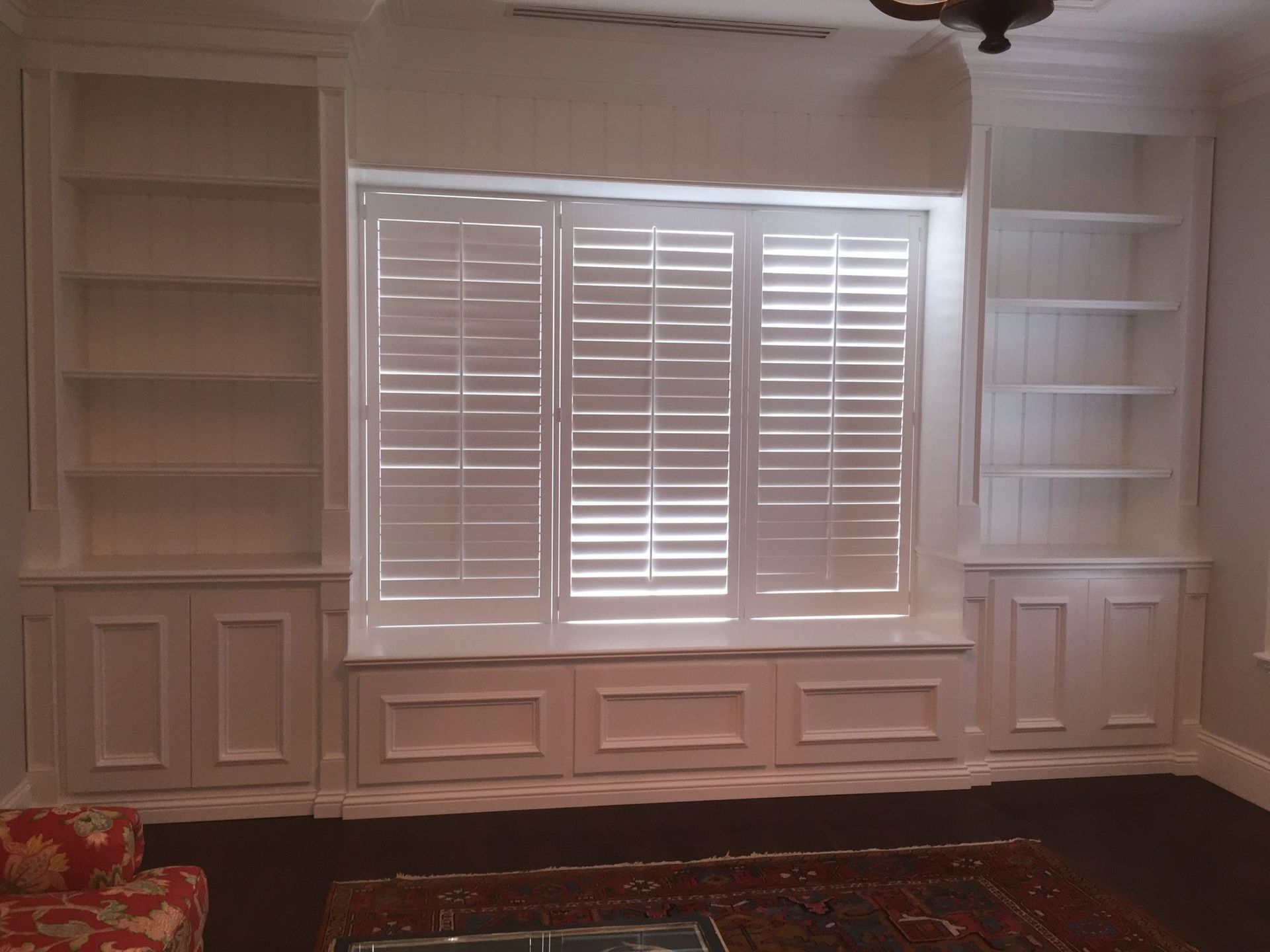 Custom built-in window seat with shelving — luxury carpentry West Palm Beach