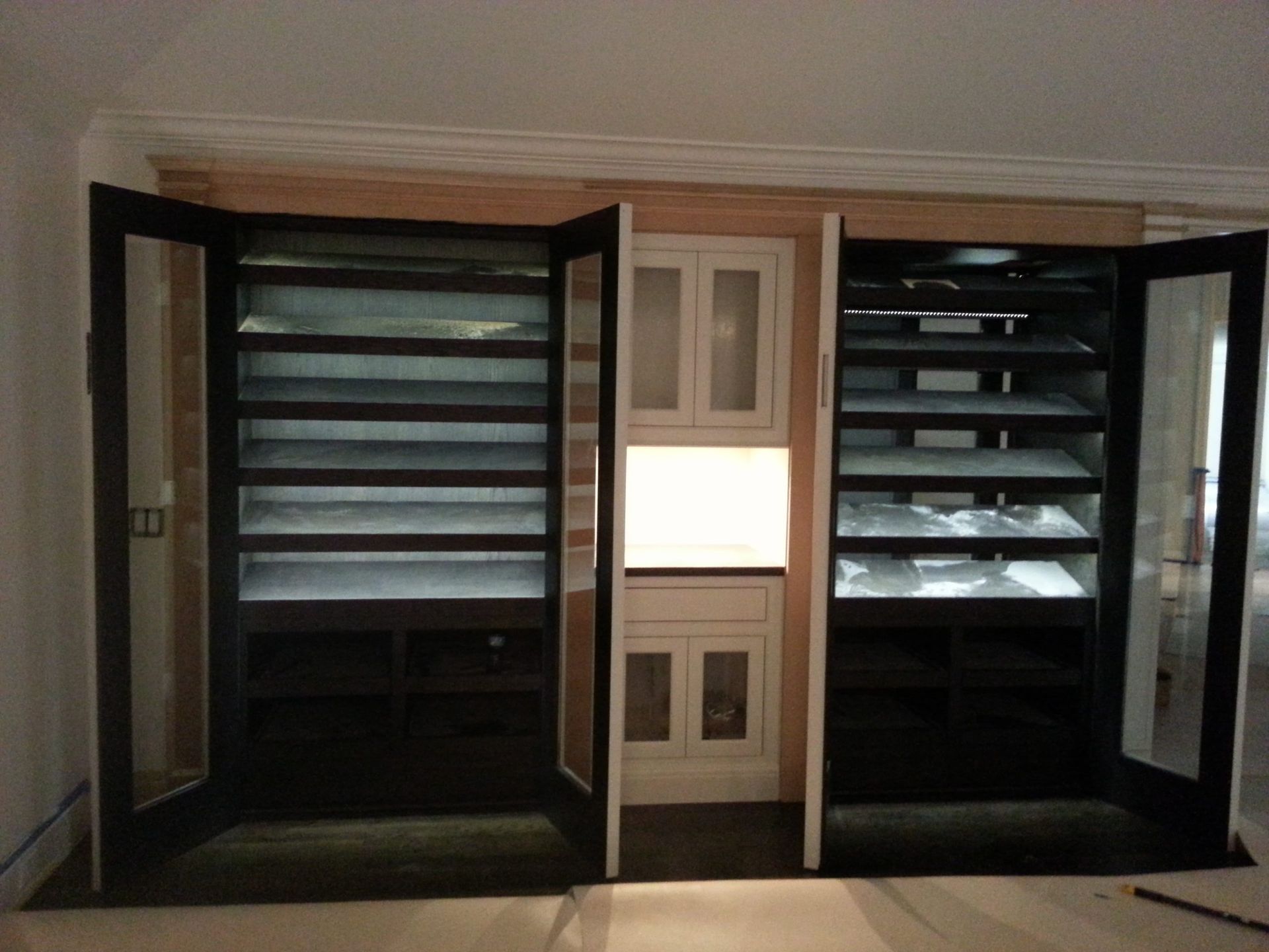 Custom built-in window seat with shelving — luxury carpentry West Palm Beach