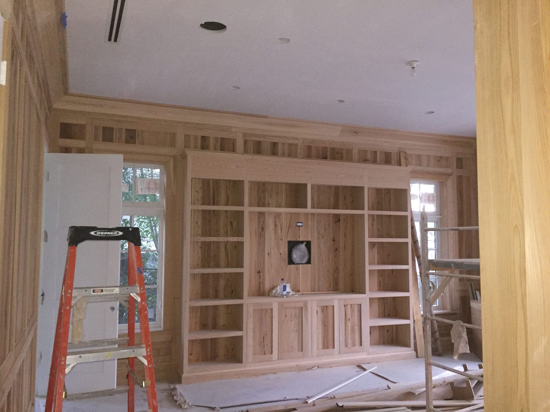 Custom built-in window seat with shelving — luxury carpentry West Palm Beach