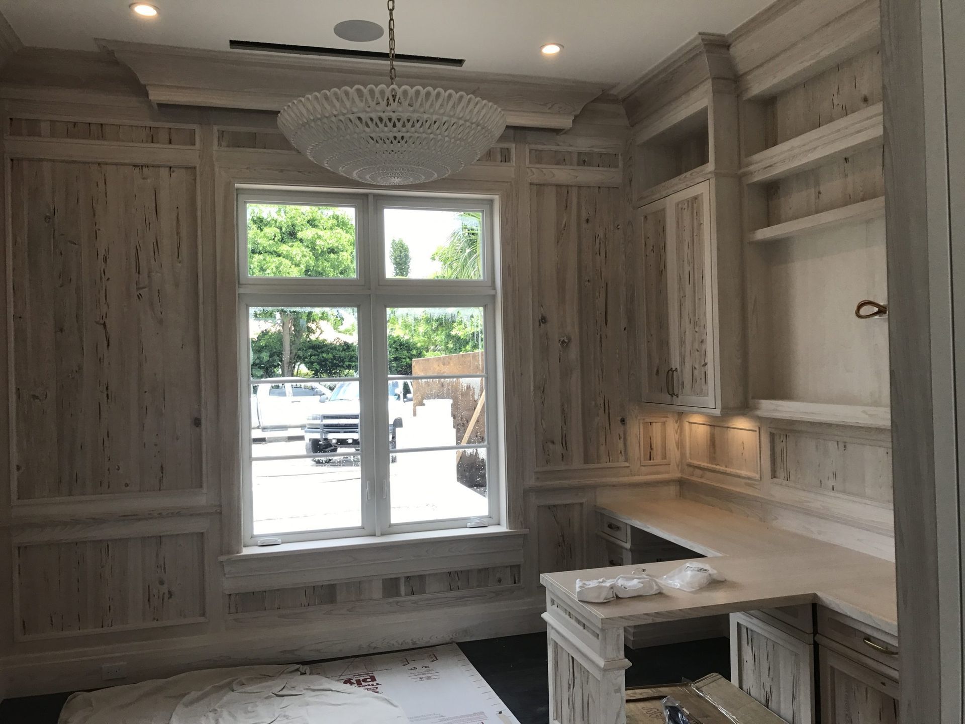 Custom built-in window seat with shelving — luxury carpentry West Palm Beach