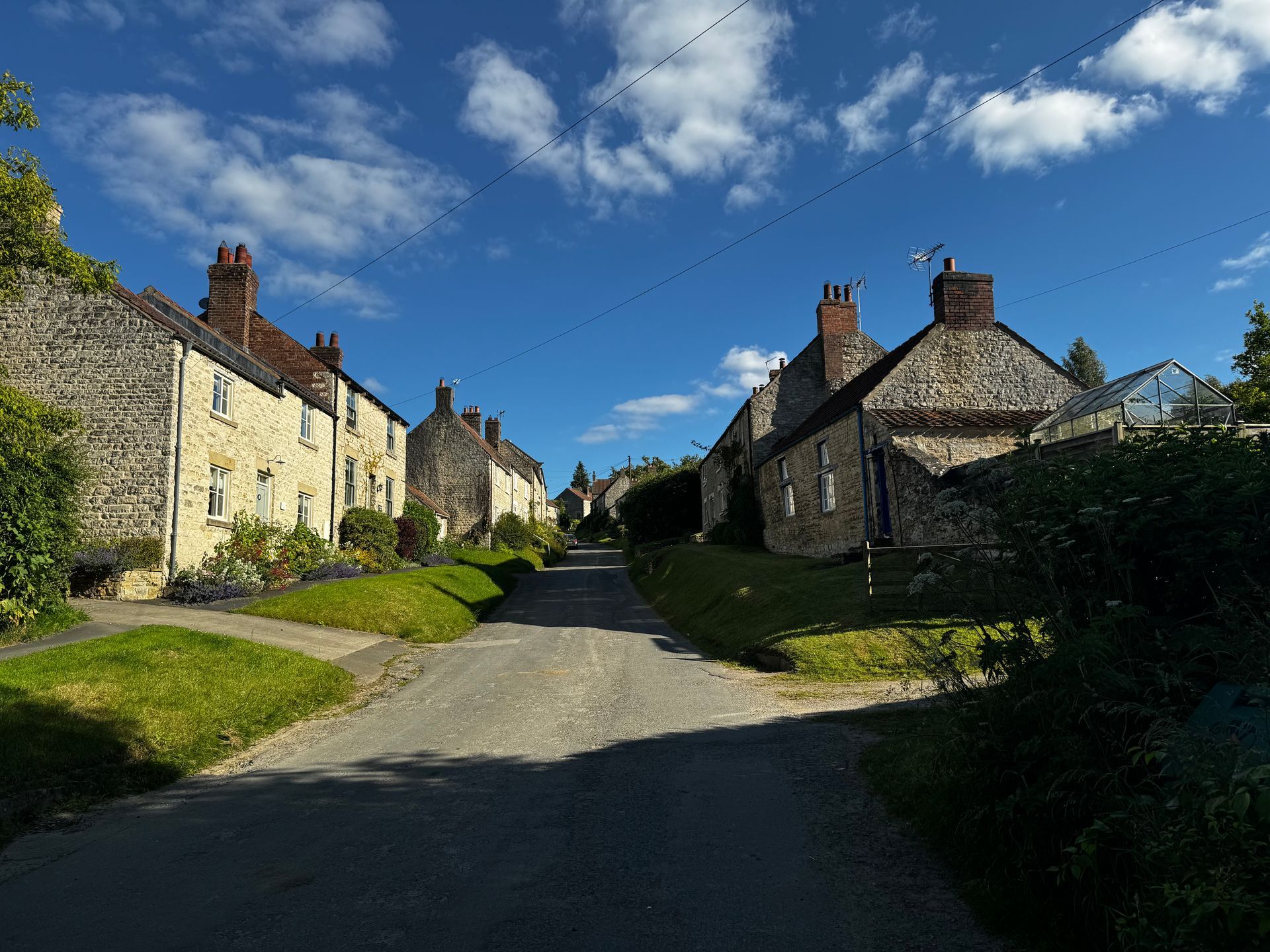A row of houses are lined up on the side of a road.