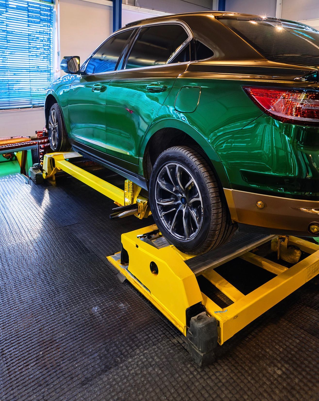 The image shows a Buick like vehicle racked on a hoist ready to be repaired and serviced by our expert auto mechanic in Redwood City, CA