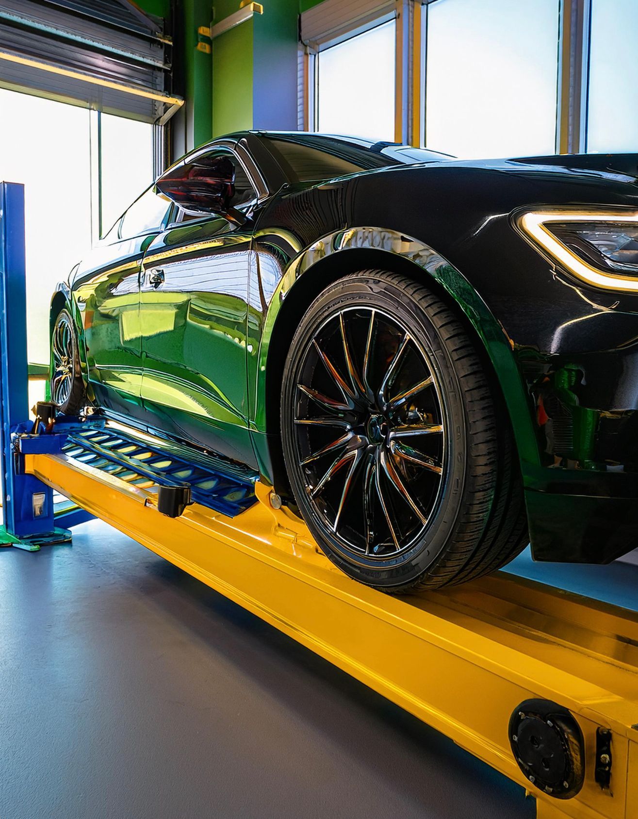 The image shows a Cadillac-like vehicle racked on a mechanics rack ready for our Cadillac repair expert to perform automotive service and repair in redwood city, CA.