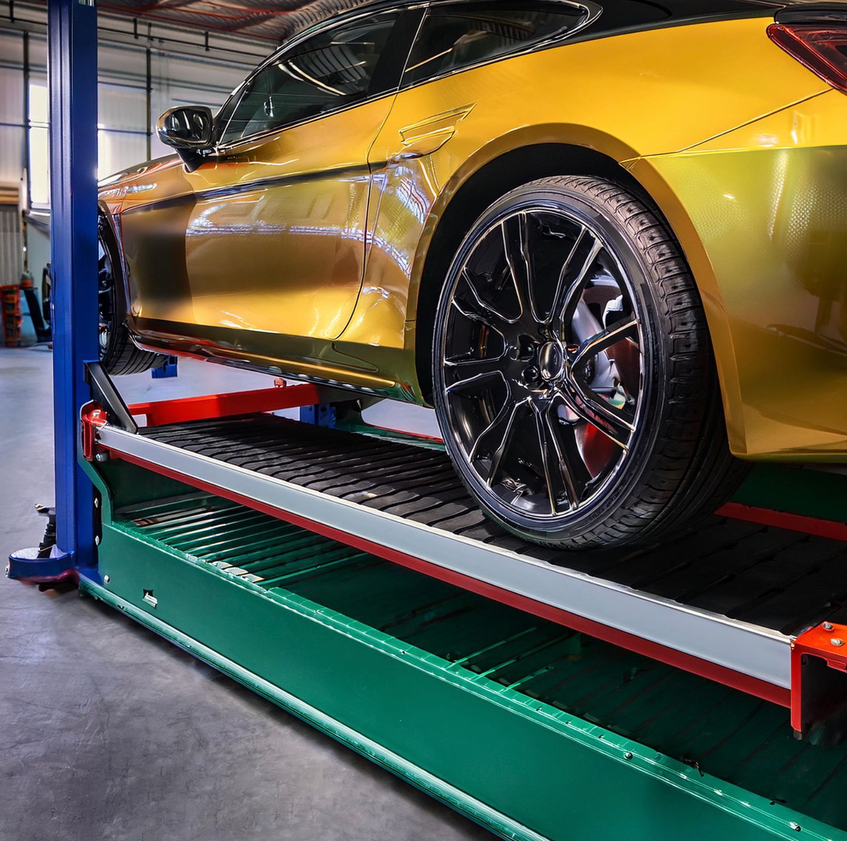 The image shows a Mazda like vehicle racked on our mechanics hoist in Redwood City, CA.  Our expert mechanics racked the vehicle and prepared it for auto repair and service.