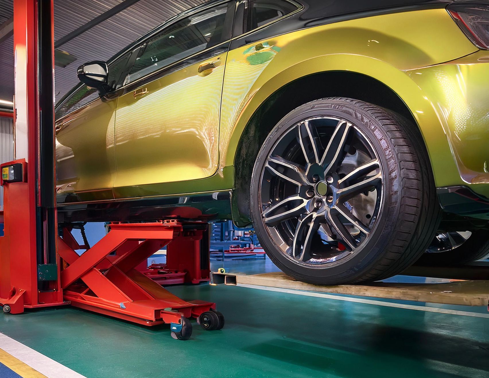 The image shows a mini type vehicle racked on our auto repair mechanics vehicle hoist in preparation for auto repair and service in Redwood City, CA.