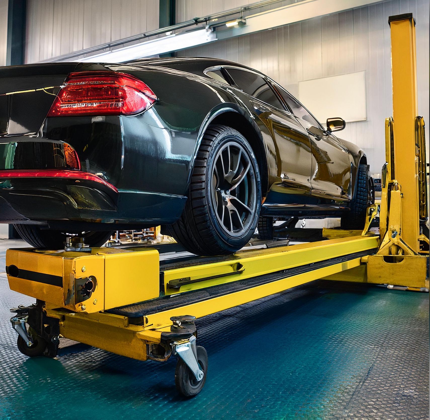 The image shows a Nissan like vehicle racked on our auto repair mechanics rack in preparation for auto repair and service in our Redwood City, CA location.