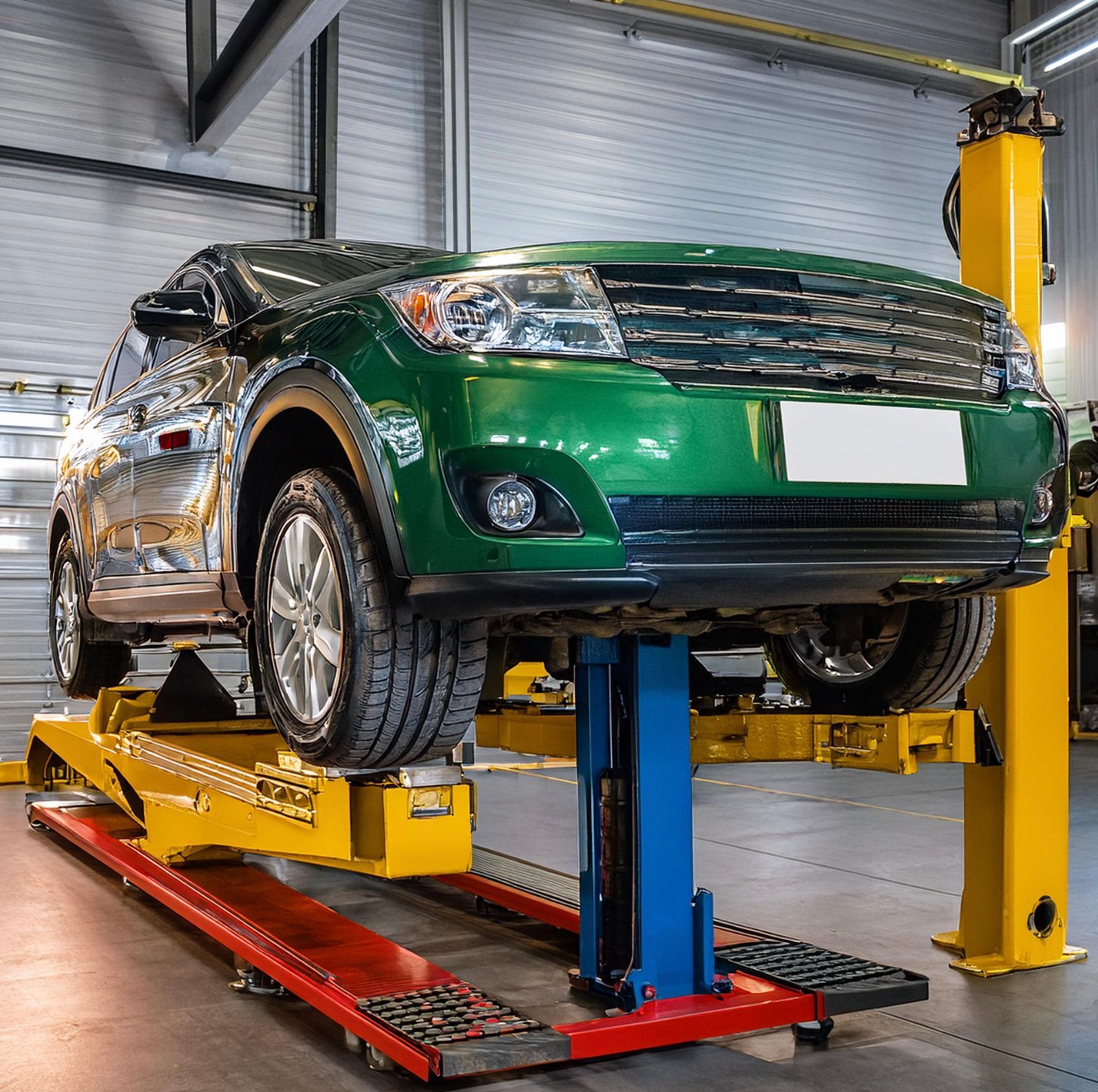 The image shows a Pontiac like vehicle racked on a mechanics rack prepped for auto repair and service in Redwood City, CA