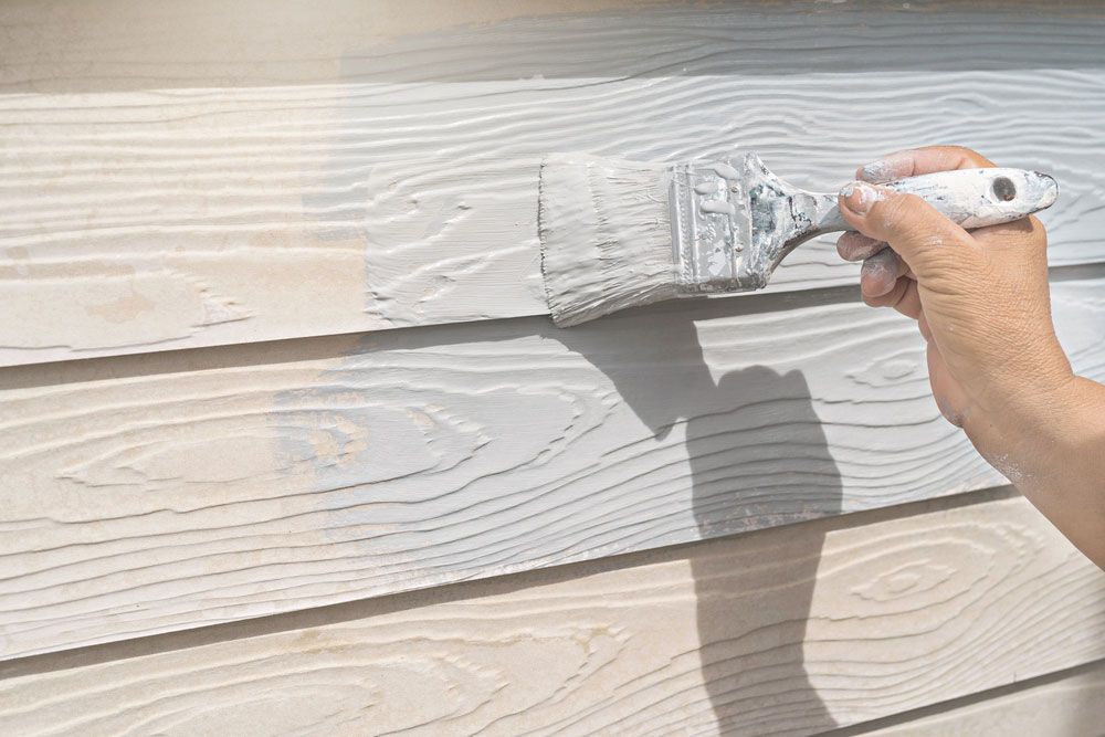 Skilled Craftsman Painting a new Wooden wall in a Construction site House — Painters in Denman, NSW
