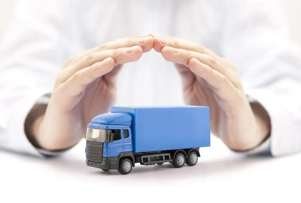 Hands Cupped Over a Small Blue Semi-truck — SSP Insurance In Rockhampton City, QLD
