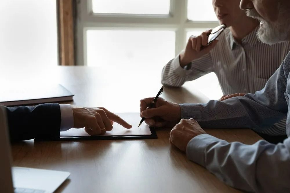 Three People at a Table — SSP Insurance In Rockhampton, QLD