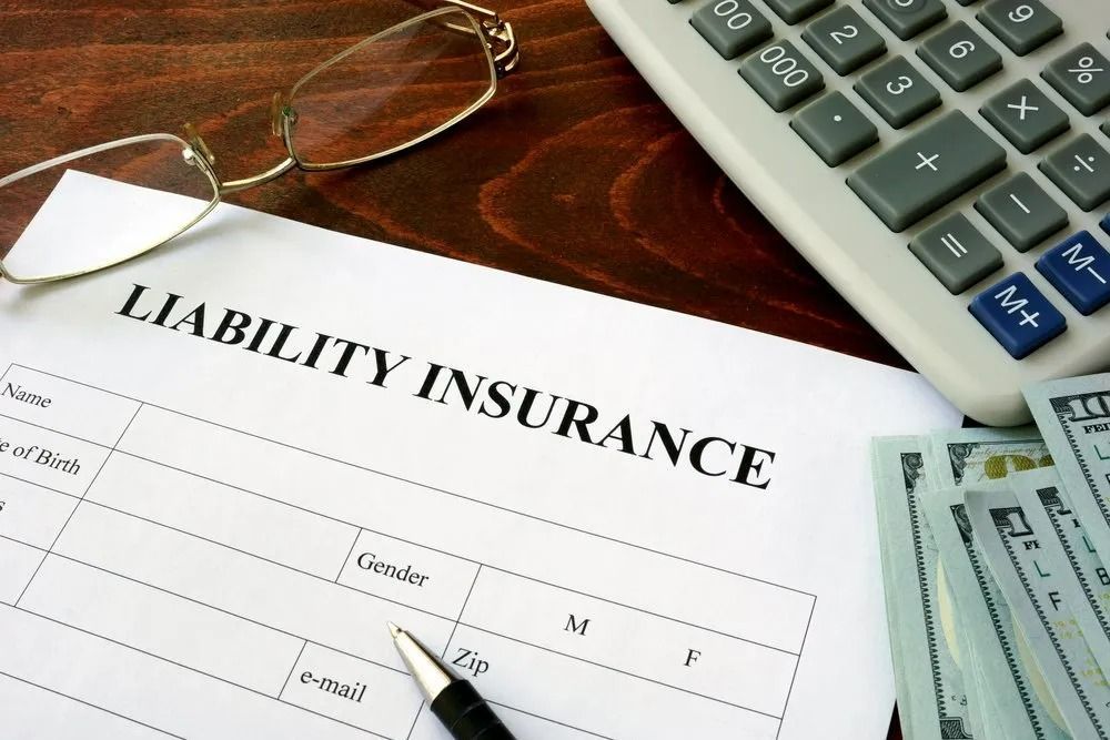 Liability Insurance Form With Glasses, Calculator, Pen, and Cash — SSP Insurance In Rockhampton, QLD