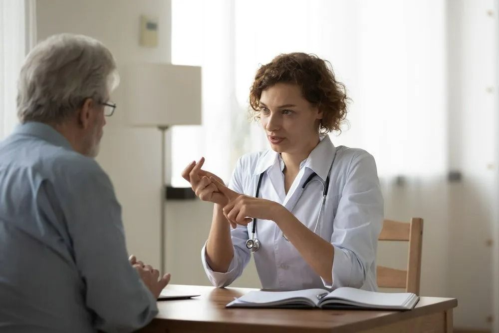 Doctor Consults With a Patient in an Office Setting — SSP Insurance In Mackay, QLD